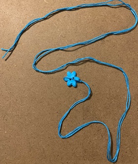 using button to measure embroidery floss loop